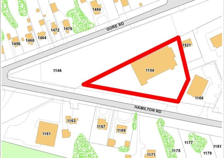 The building sits on a triangle-shaped lot at the corner of Hamilton and Gore Roads that is surrounded by residential properties. 