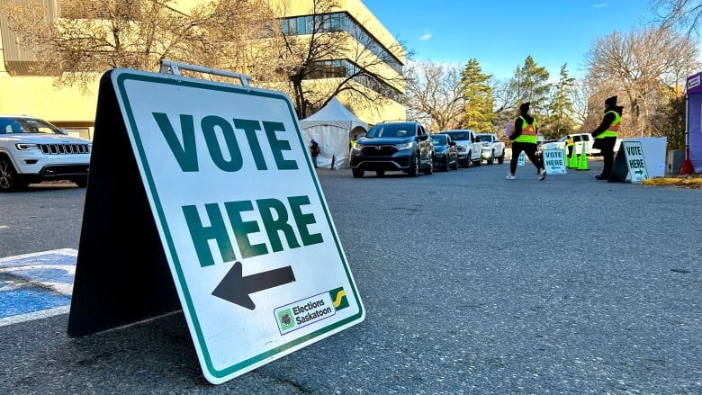 A white sign with green lettering notes that residents can 