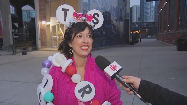 Photo of a woman dressed in a friendship bracelet costume. 