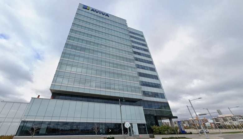 A tall glass office building with the name 