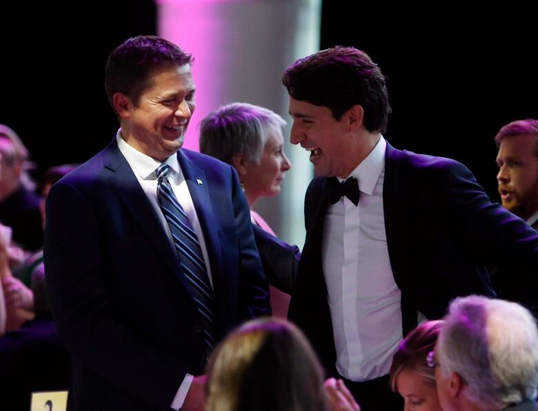 Prime Minister Justin Trudeau (right) shares a laugh with Conservative Leader Andrew Scheer as they attend the National Press Gallery Dinner in Gatineau, Quebec on Saturday June 3, 2017.