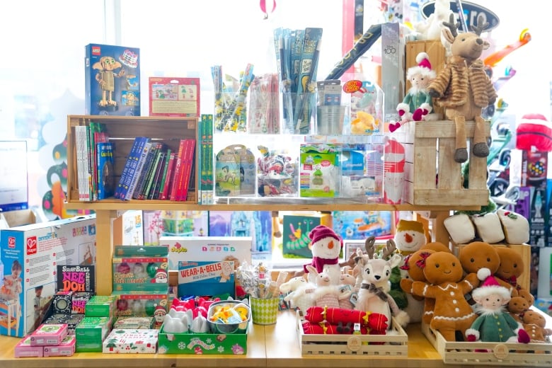 Toys sit on a shelf in a toy shop.