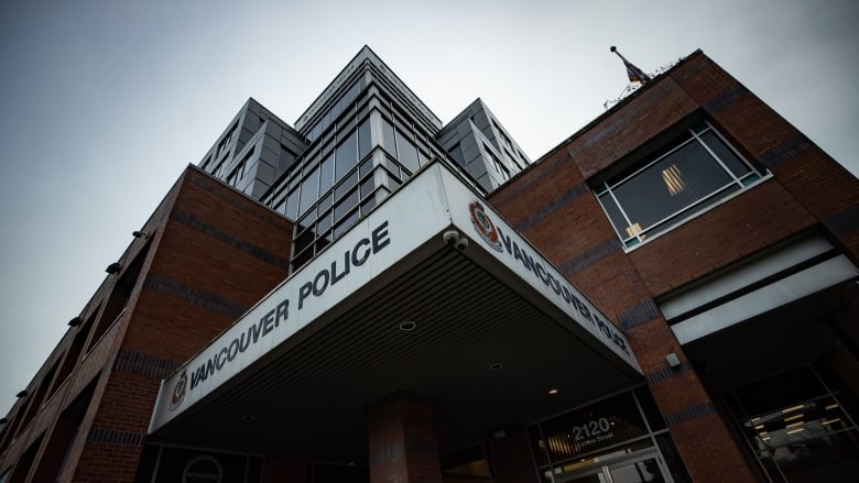 A building that reads 'Vancouver Police' on a cloudy day.