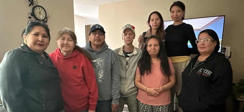 Eight people pose for a group photo. 